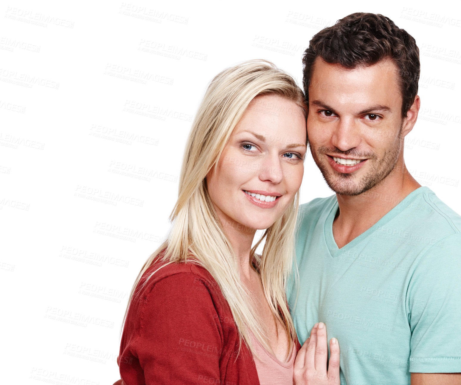 Buy stock photo Portrait of a good looking couple standing together and smiling at the camera with a white background