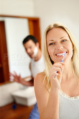 Buy stock photo Couple, happy and brushing teeth in bathroom in morning for love, bonding and hygiene with toothbrush. Man, woman and dental care in house together for cleaning mouth, relationship and 