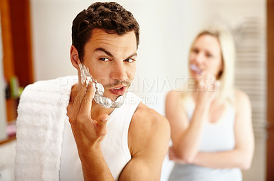 Buy stock photo Shaving, brushing teeth and couple in bathroom with mirror, hair removal and getting ready together. Skincare, woman and man with toothbrush, foam and beard care in morning cleaning routine at home