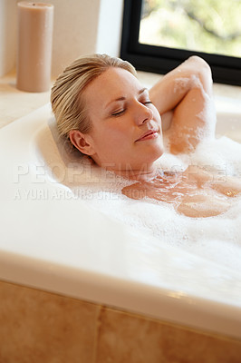 Buy stock photo A happy young woman relaxing in a luxurious foam bath