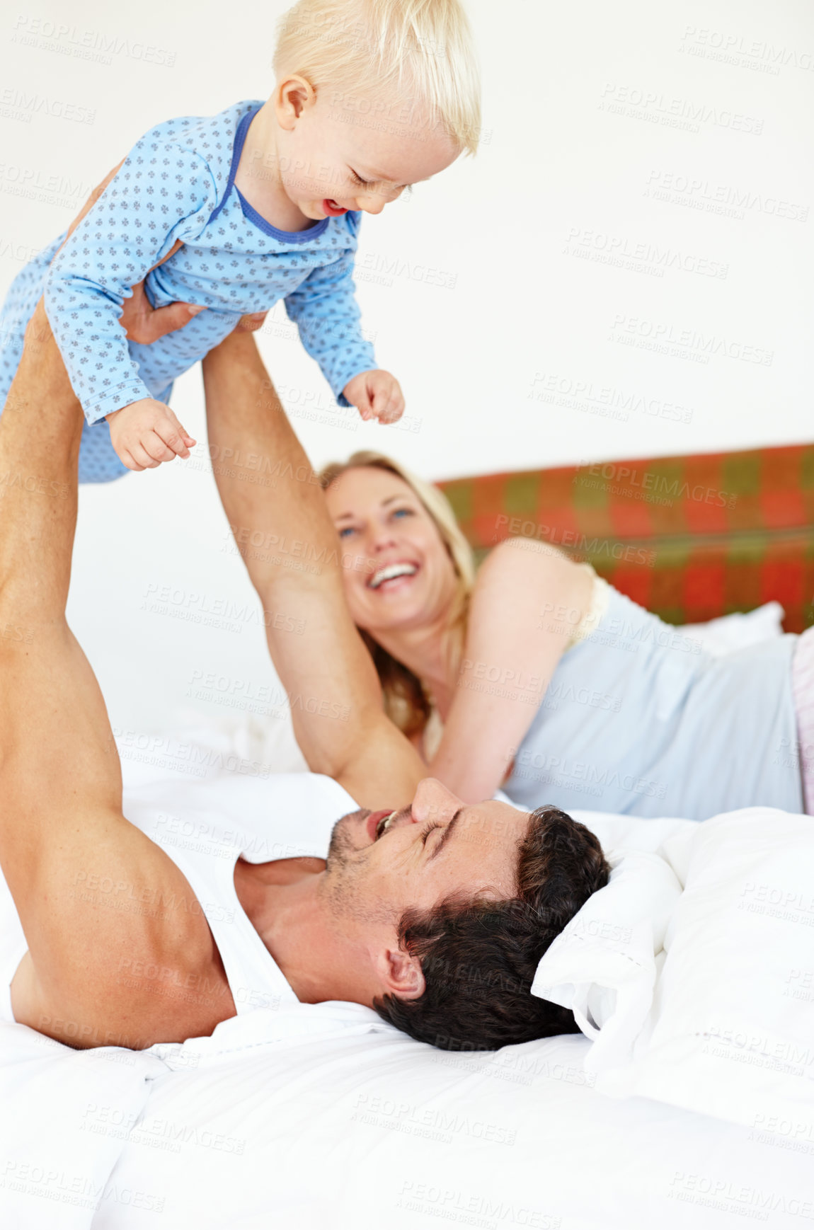 Buy stock photo Love, airplane and parents lifting baby on bed with fun, bonding and playing morning games at home together. Family, learning or people in bedroom with security, trust or child development or balance