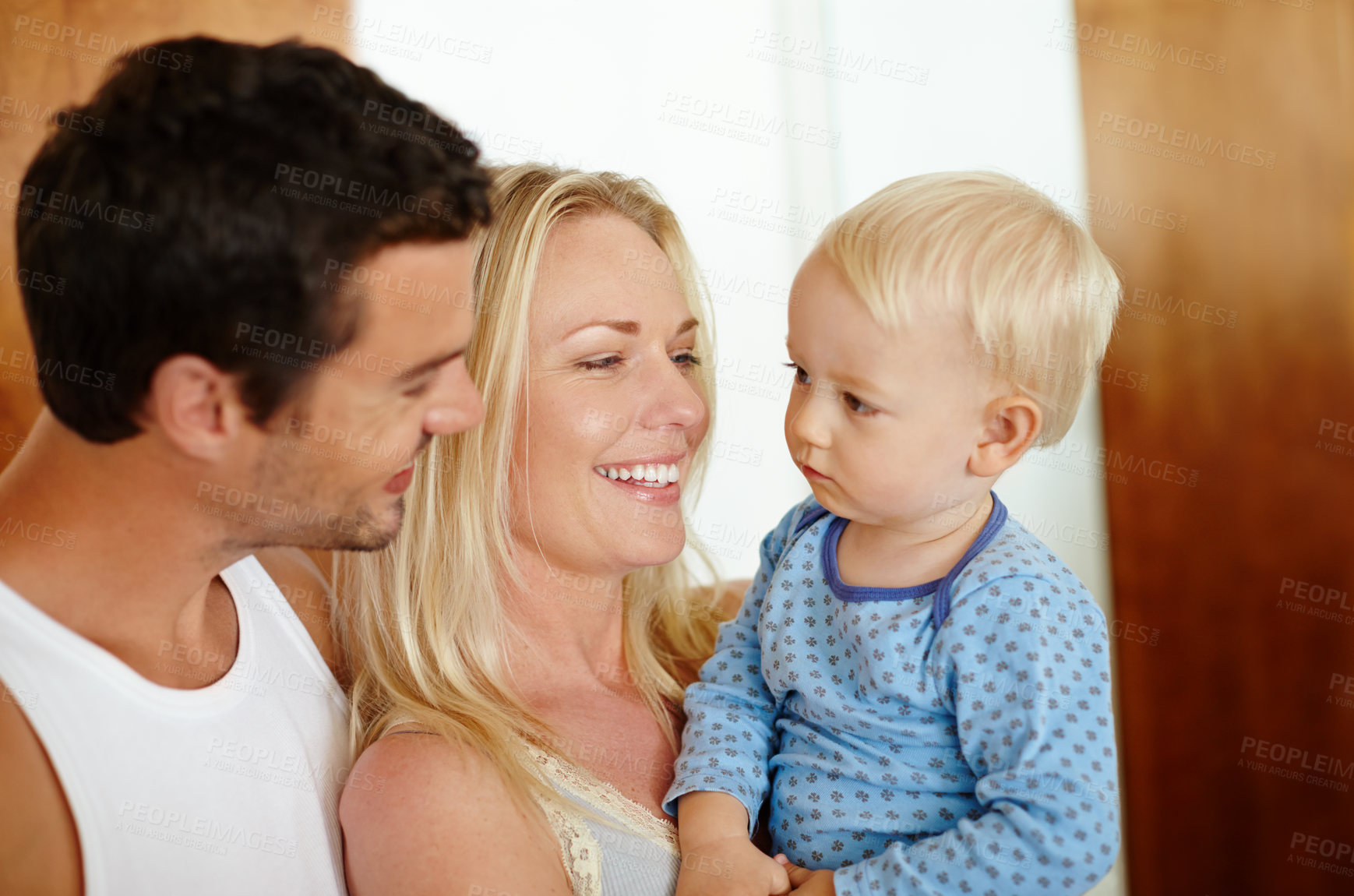 Buy stock photo Happy, love and parents with baby in a house for fun, learning or bonding in their home together. Family, support or kid with people in living room for morning, games and security, safety or teaching