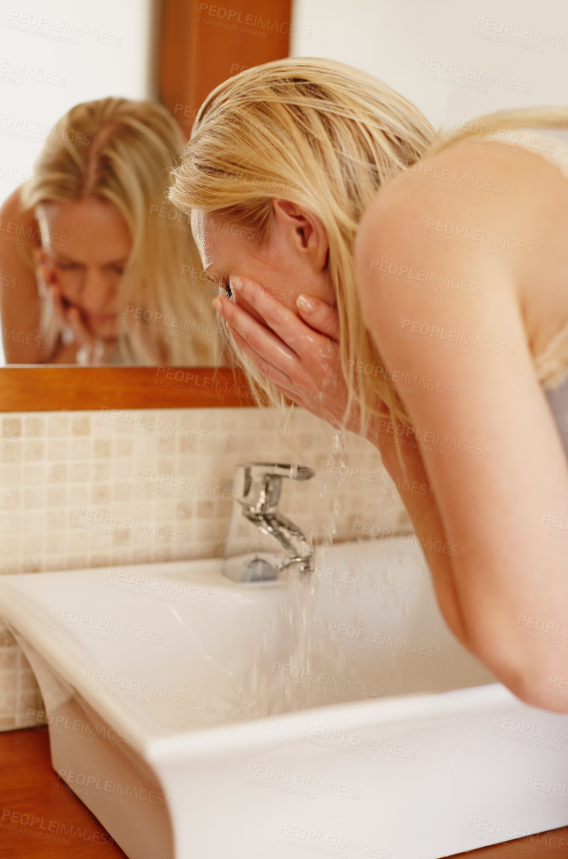 Buy stock photo Bathroom, sink and woman washing face in a house for skincare, wellness and morning refreshing routine. Water splash, cleaning and girl person with facial, cleanse or hydration, grooming or beauty