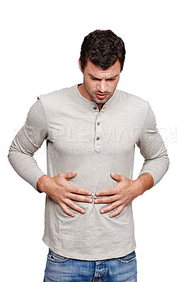 Buy stock photo Stomach ache, pain and sick with a man in studio isolated on a white background holding his tummy in discomfort. Colon, digestion and digestive with a male rubbing his abdomen due to constipation
