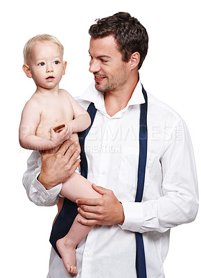 Buy stock photo A businessman holding his son after a long day at work