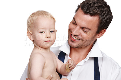 Buy stock photo A doting young father holding his son after a long day at work