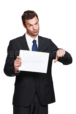 Buy stock photo A handsome young businessman holding a placard and giving you a thumbs down