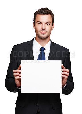 Buy stock photo A handsome young businessman holding a blank placard while isolated on white