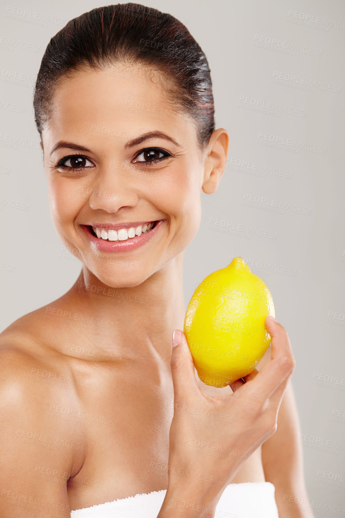 Buy stock photo Woman, vitamin c skincare and lemon in portrait for bright skin, vegan cosmetics and gray background. Female person, natural product and dermatology for detox, hydration and citrus for beauty studio