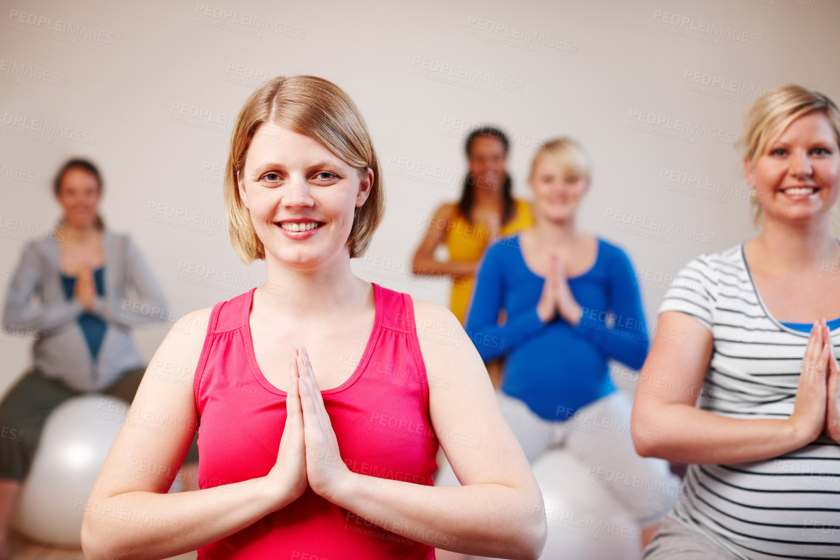 Buy stock photo Prayer hands, woman and pregnancy class with group, portrait and smile on ball together. Relax, stretch and hip support and wellness for child birth, fitness and female people for balance exercise 