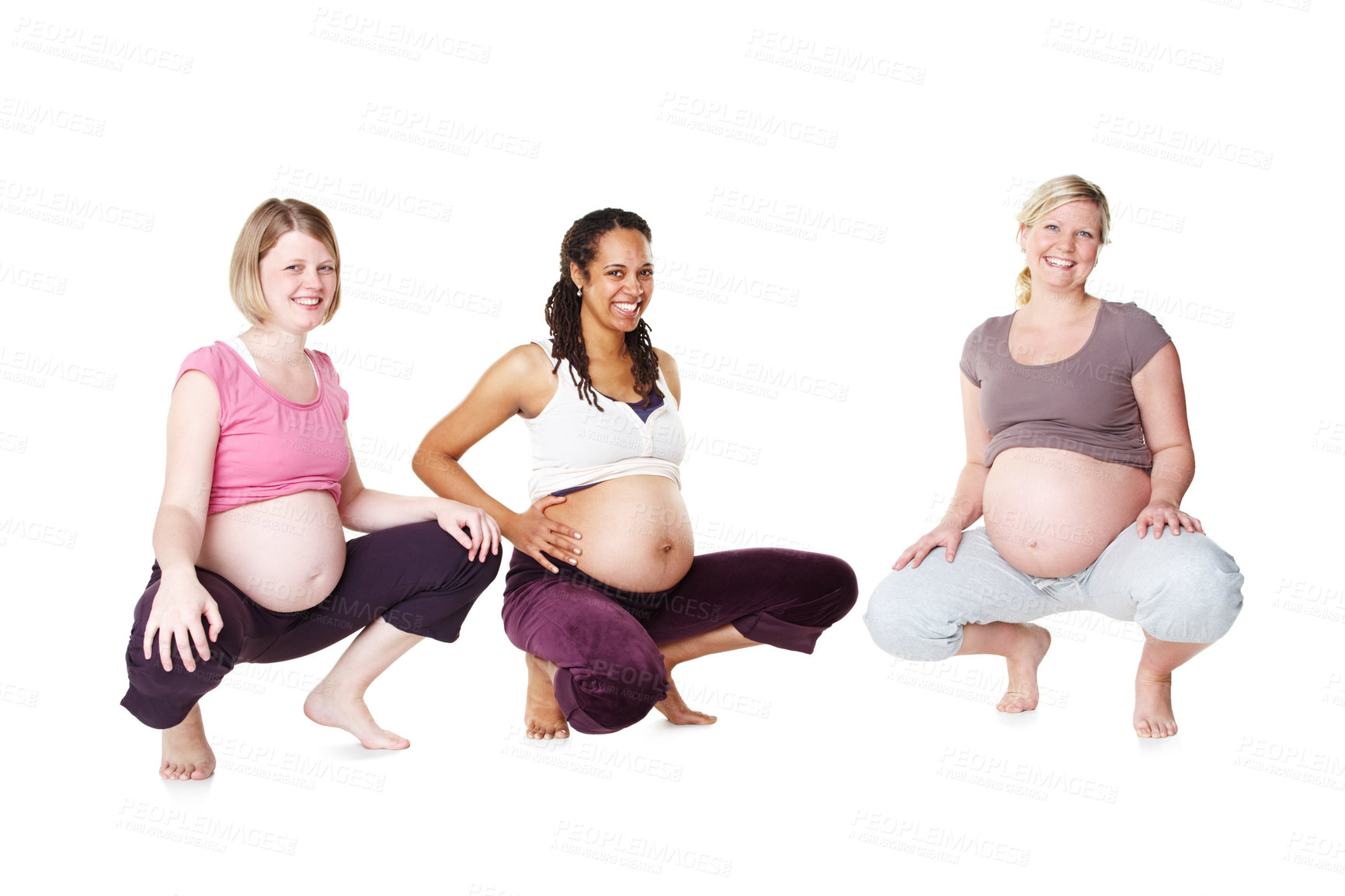 Buy stock photo Three pregnant women crouching and smiling while isolated on a white background