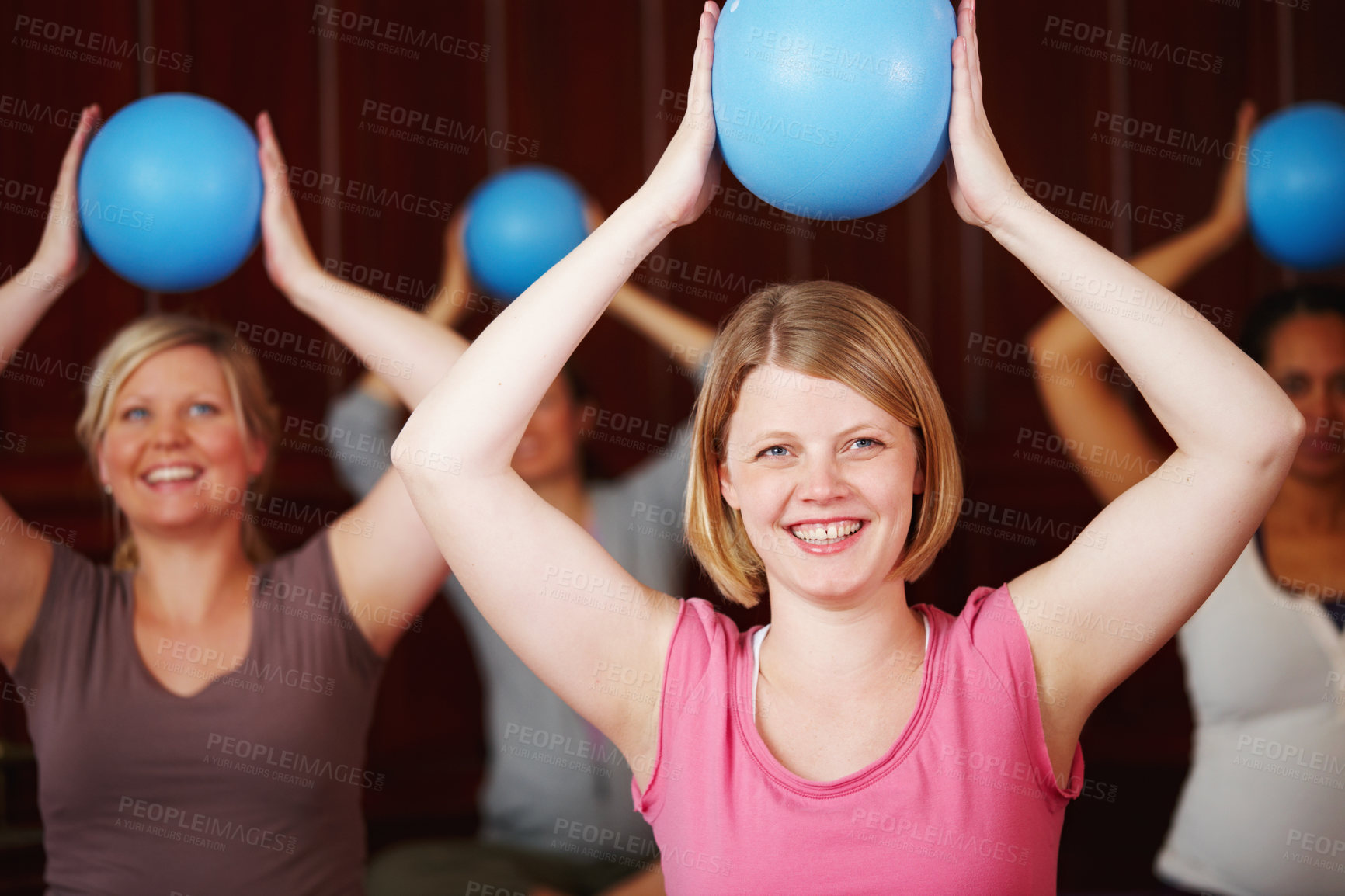 Buy stock photo Pilates, fitness and training of a happy woman in a health and wellness class in a yoga studio. Ball workout and exercise of a relax female from Germany with a smile trying to be healthy at a gym