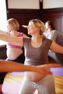 Buy stock photo Women, pregnancy and yoga class for stretching, health and wellness with energy, stomach and smile. Motherhood, prenatal and exercise in studio for fitness, maternity and body awareness with abdomen