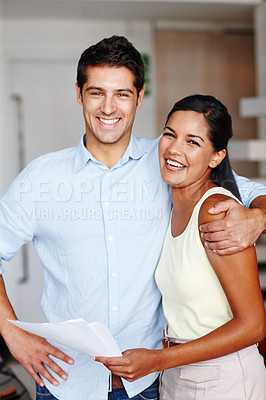 Buy stock photo Two friendly colleagues hugging one another in the office