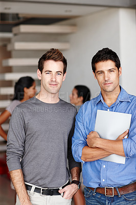 Buy stock photo Portrait of two creative associates standing together in the office following a successful meeting
