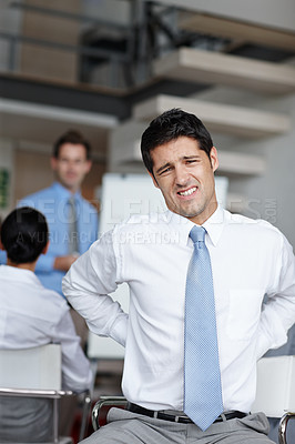Buy stock photo A young businessman dealing with lower back pain