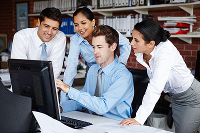 Buy stock photo A young business team collaborating on a project together 