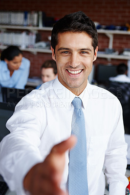 Buy stock photo A handsome young businessman welcoming you to the team