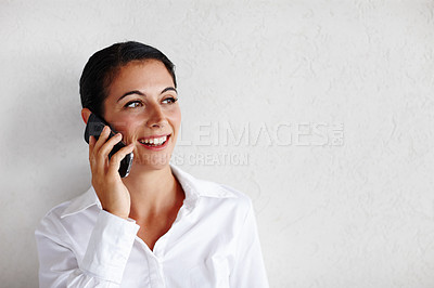 Buy stock photo A pretty businesswoman taking a call and looking towards copyspace