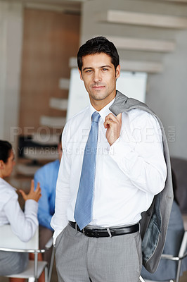 Buy stock photo Portrait of a handsome young businessman with his suit jacket over his shoulders