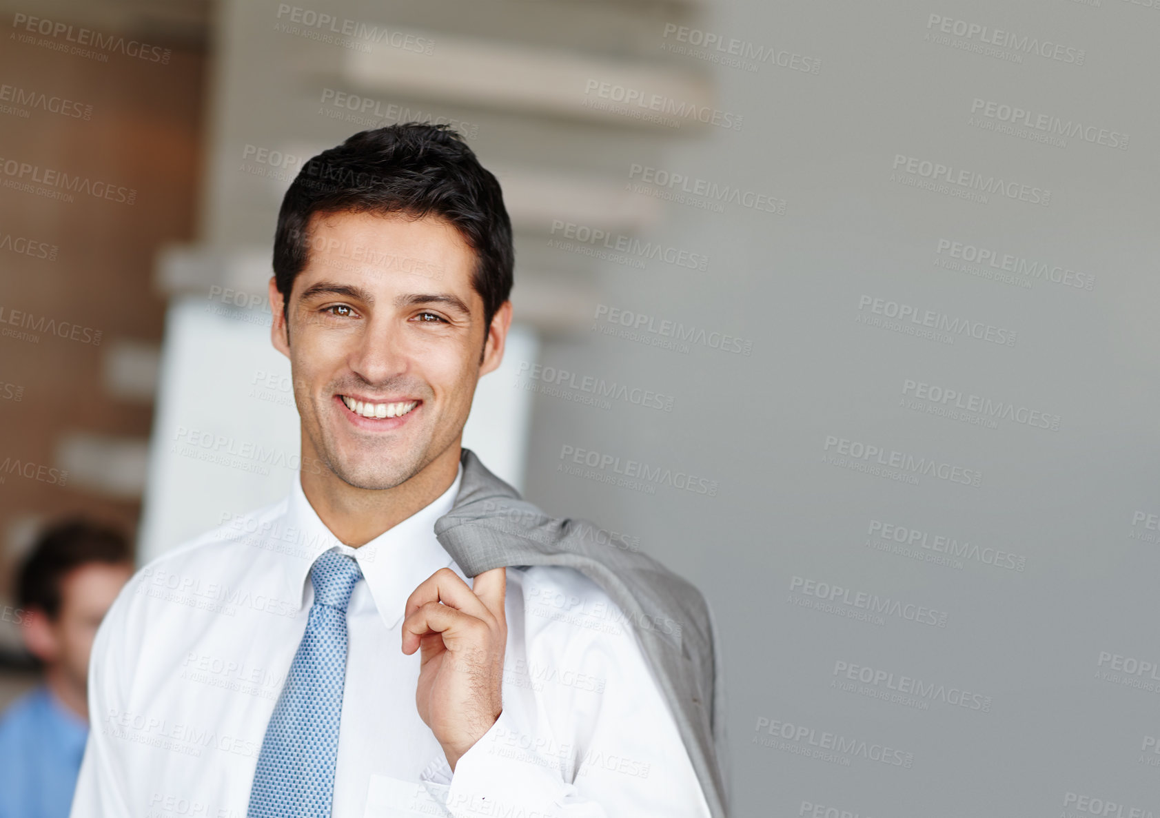 Buy stock photo Portrait of a handsome young businessman with his suit jacket over his shoulders - copyspace