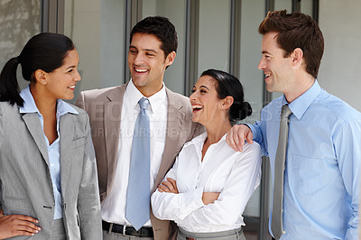 Buy stock photo A business team laughing together after a successful business pitch
