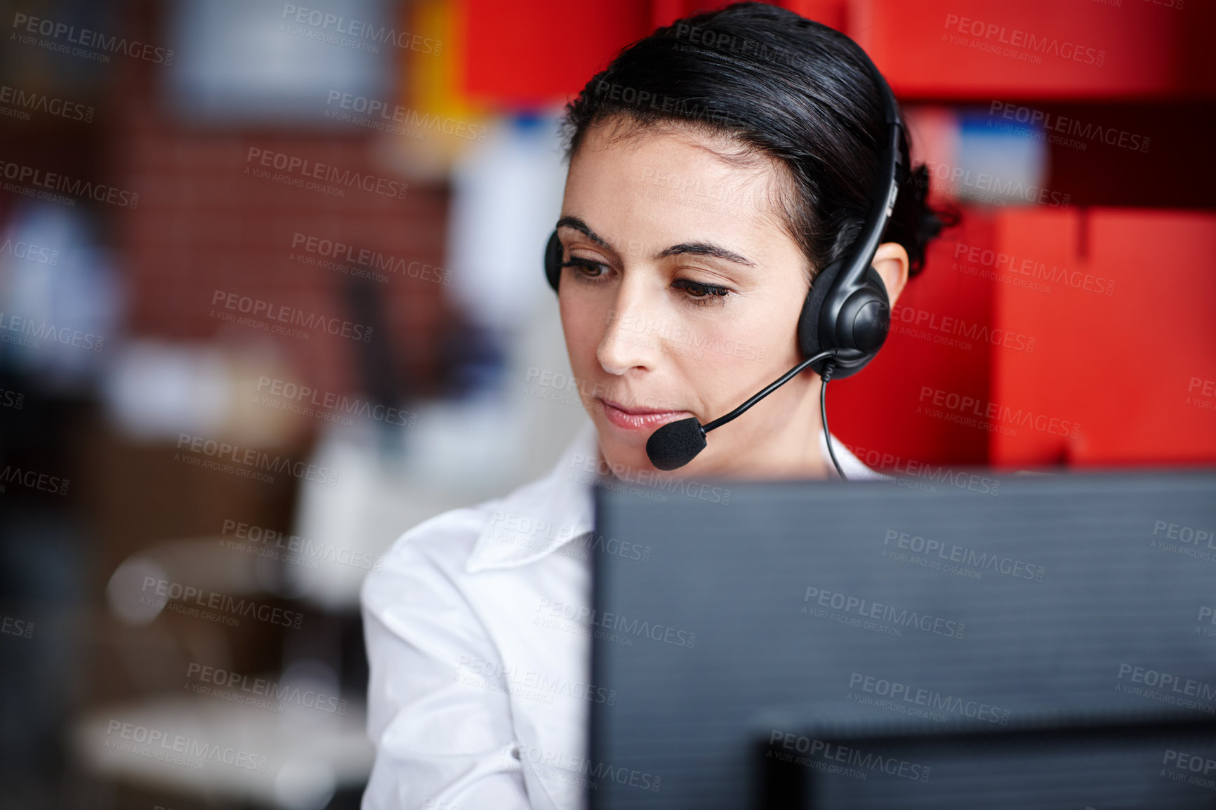 Buy stock photo A pretty call center agent assisting a client diligently