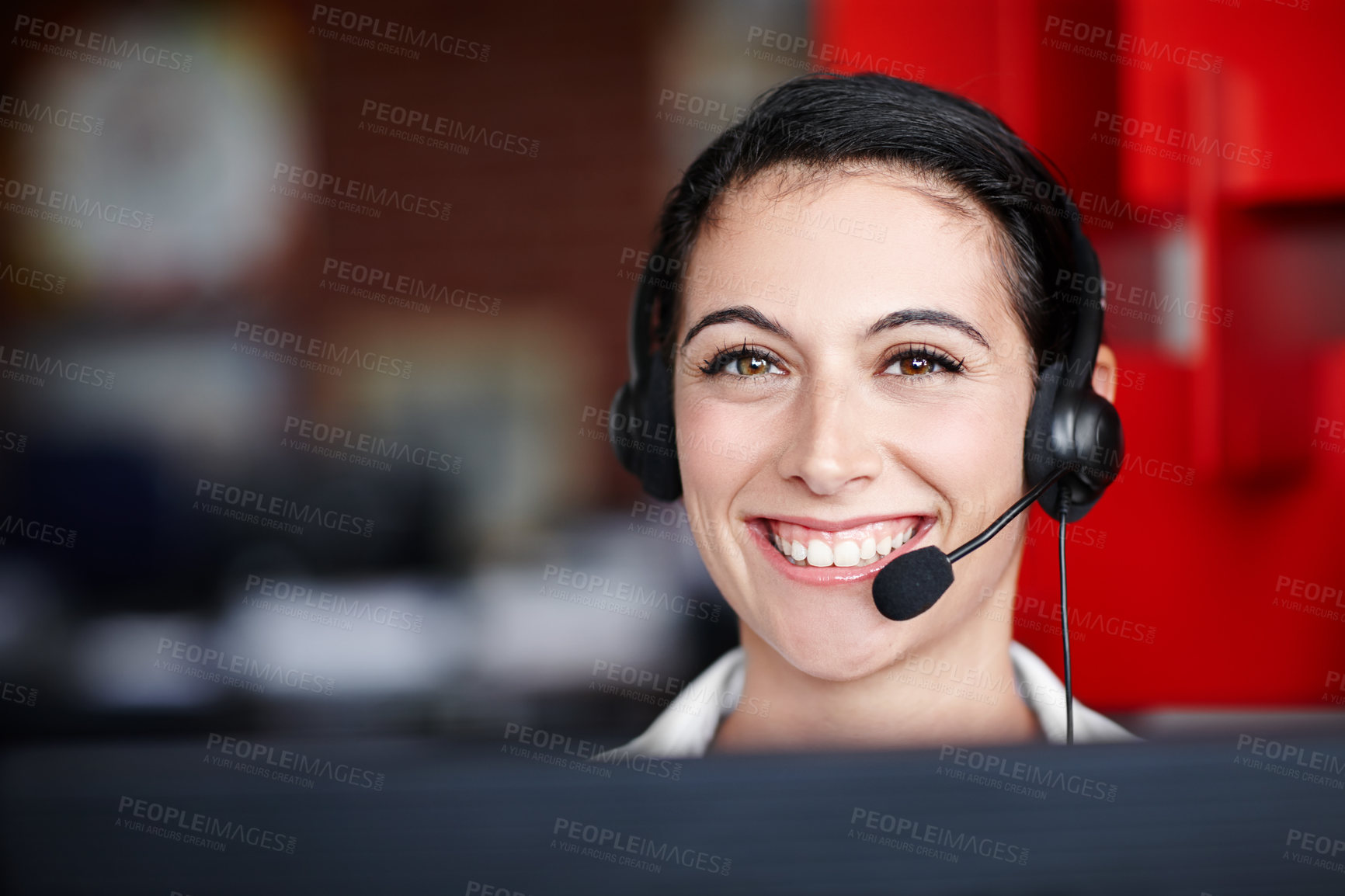 Buy stock photo Portrait of a pretty call center agent wearing a headset and sitting in front of her computer