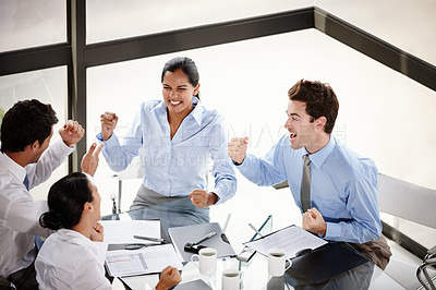 Buy stock photo A group of excited businesspeople celebrating their success in the boardroom