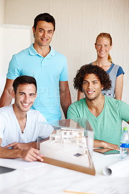 Buy stock photo A group of architects discussing a building model during a meeting