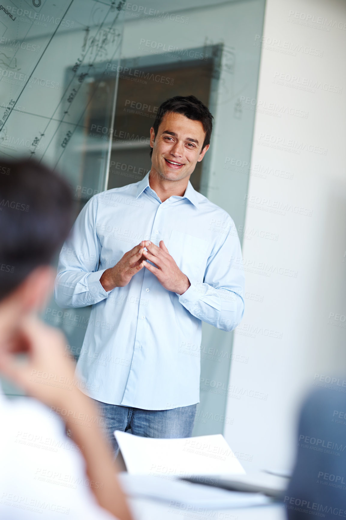 Buy stock photo Attractive casual businessman giving a presentation using a glass window for demonstration