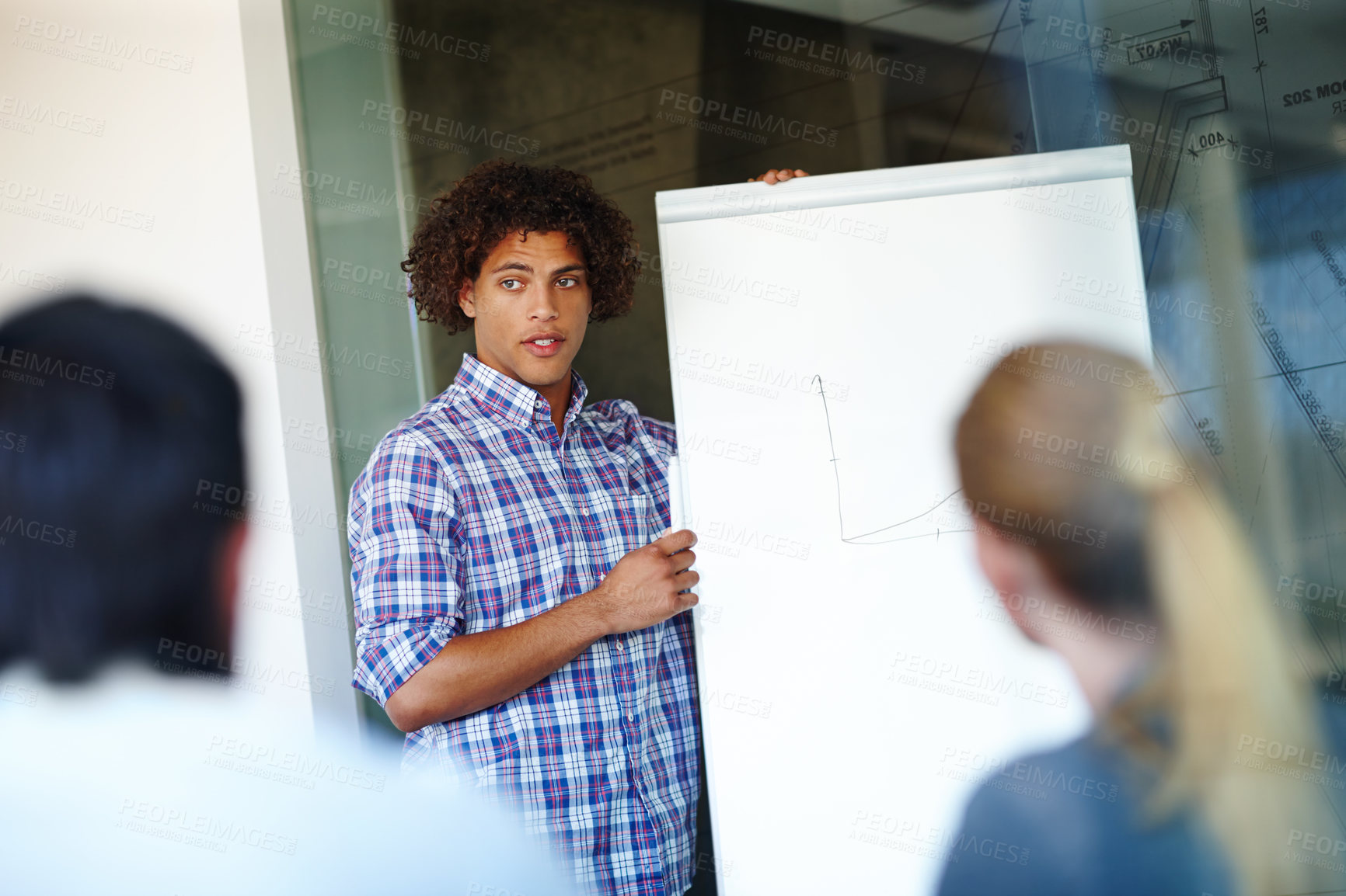 Buy stock photo Businessman, presentation and meeting with whiteboard for project or team discussion at office. Young man or speaker talking to employees for company ideas, growth or graph on revenue at workplace