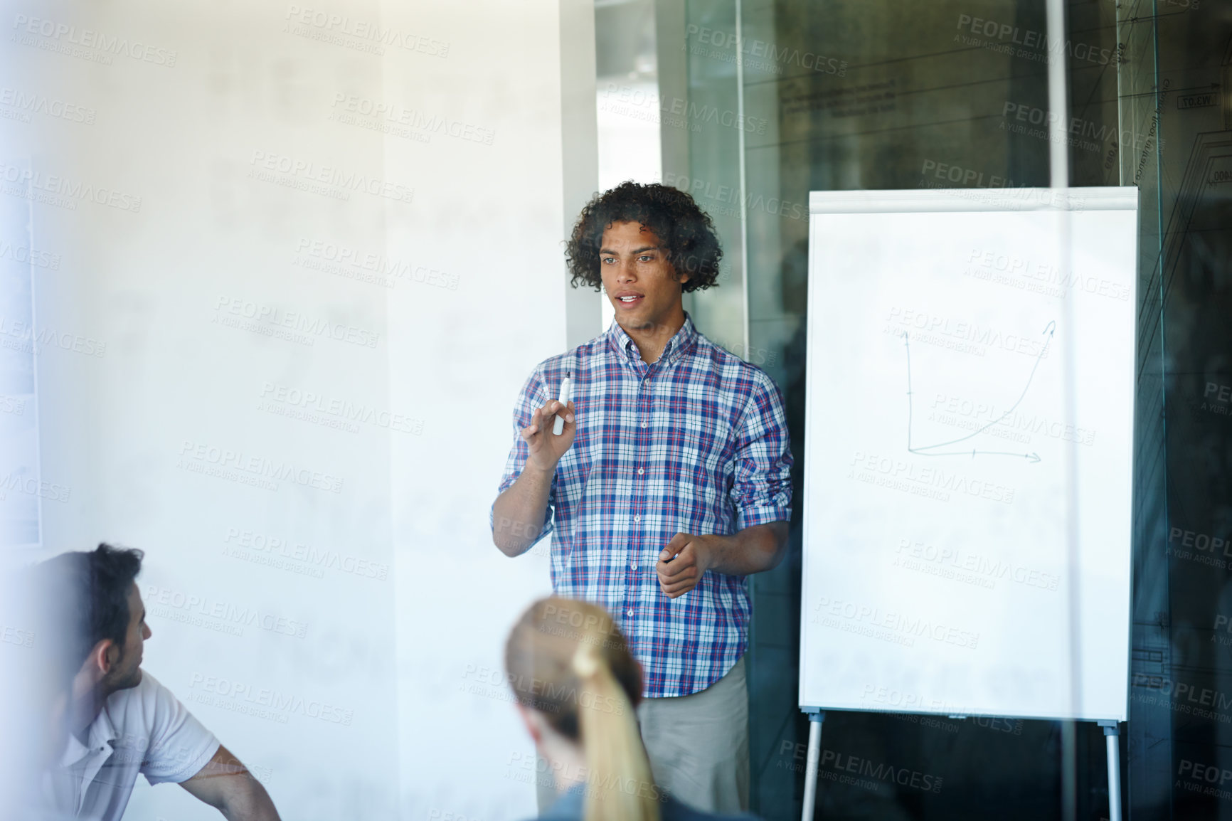 Buy stock photo Businessman, presentation and meeting with speech, whiteboard or chart for team discussion at office. Young man or speaker explaining company growth, revenue or profit to employees at workplace