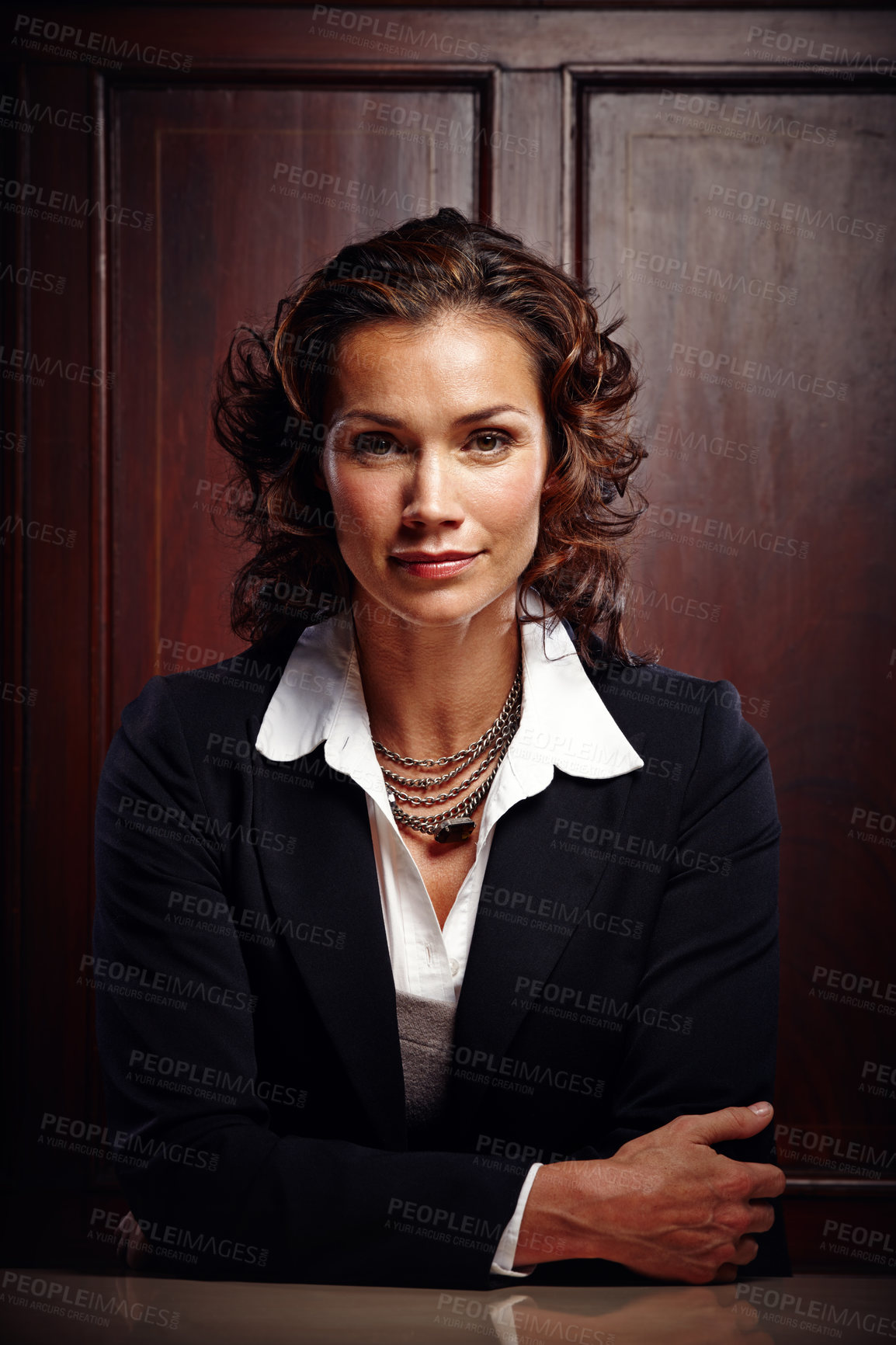 Buy stock photo Mature advocate sitting with her arms folded in front of her and smiling at the camera