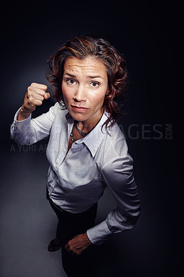 Buy stock photo Fist, stop and woman with warning, danger and caution with above isolated on dark background. Gesture, signal and security, threat and portrait, rejection and protest expression and fight in studio