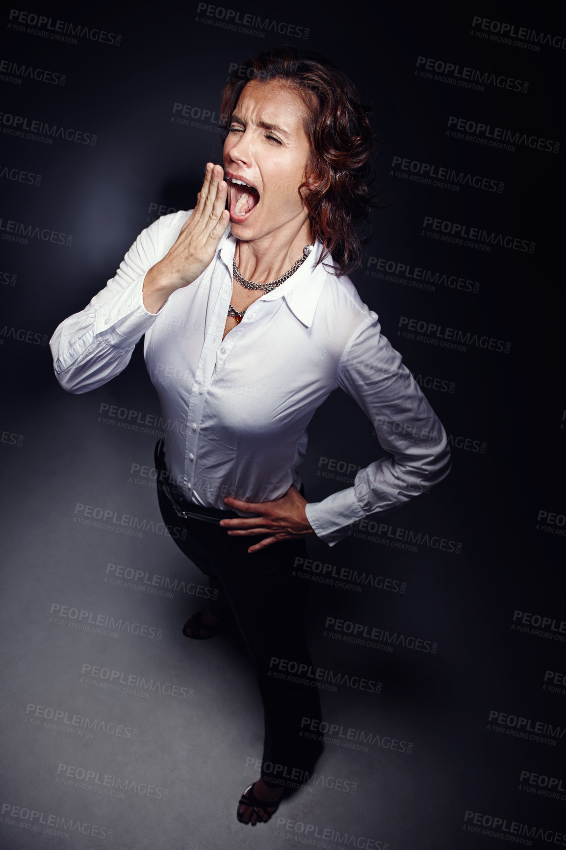 Buy stock photo Business woman, light and yawn for tired, burnout and overworked with bored, sleepy and late at night. Employee, spotlight and open mouth for fatigue, exhausted and overtime in evening with stress