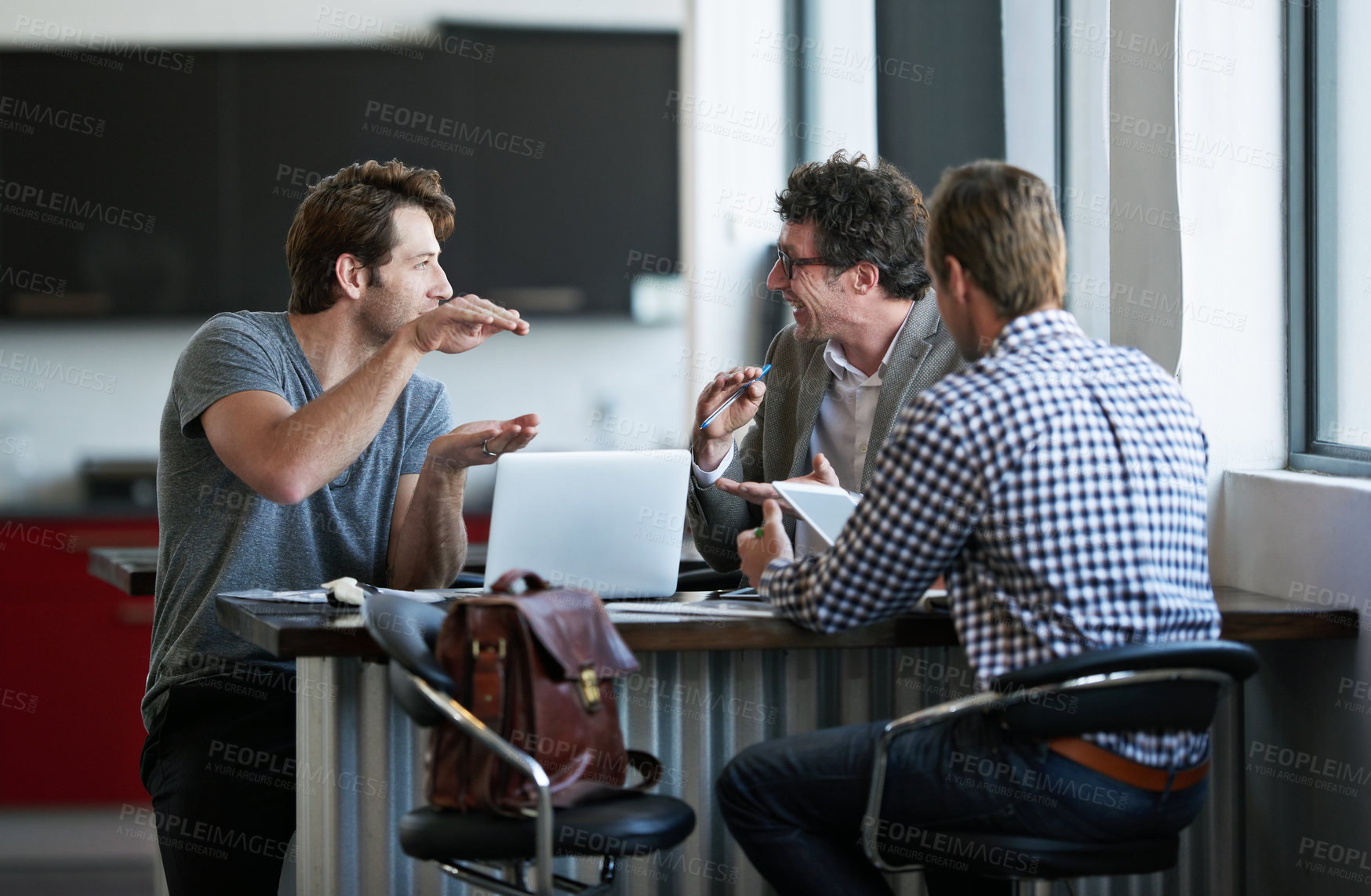 Buy stock photo Cropped shot of three businessman discussing work in the office