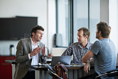Buy stock photo Cropped shot of three businessman discussing work in the office