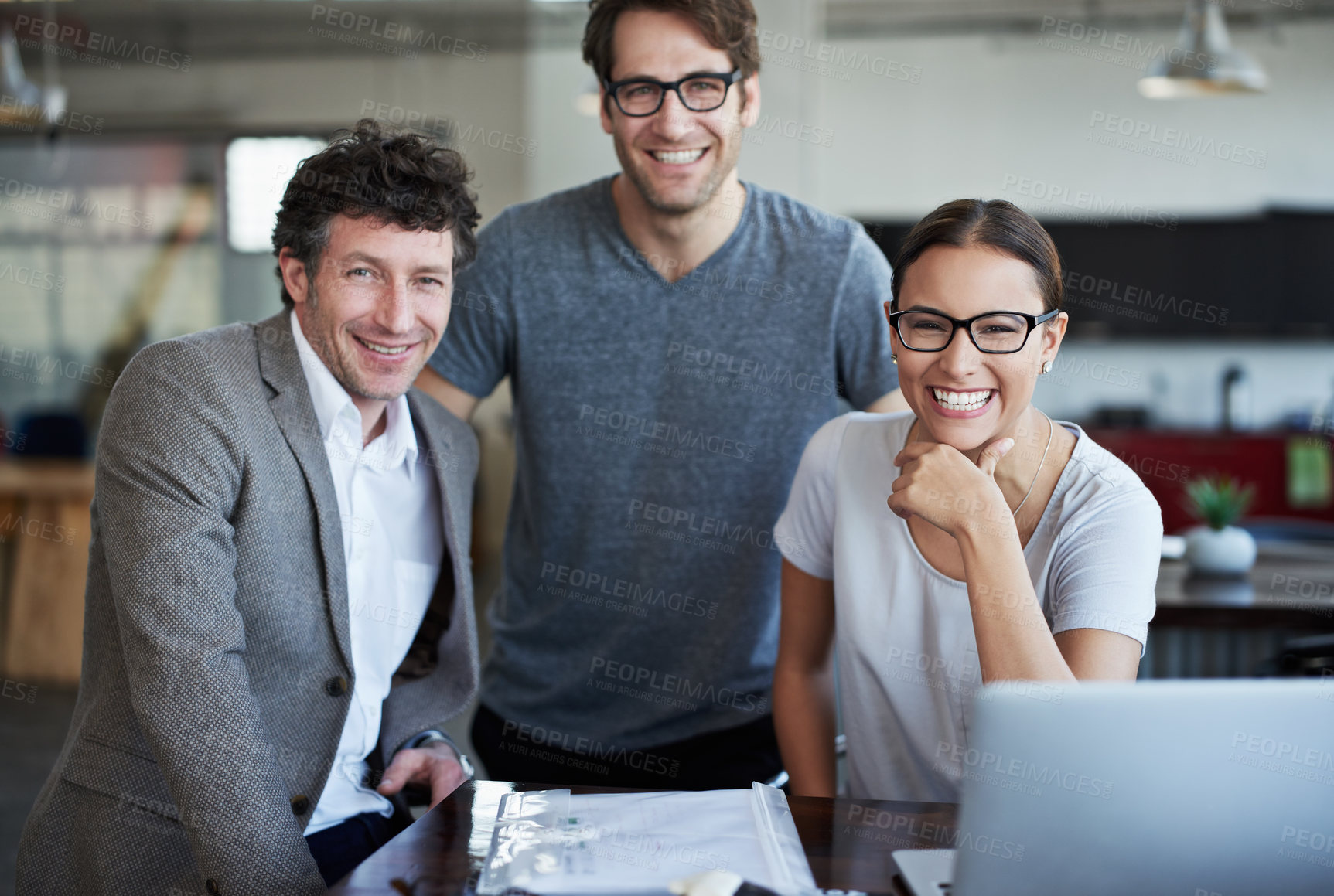 Buy stock photo People, desk and portrait with smile for team in office for meeting with planning in business. Businesspeople, table and laptop with collaboration with technology for company, teamwork and happy