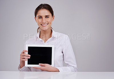 Buy stock photo Studio portrait of an attractive young woman holding a blank digital tablet