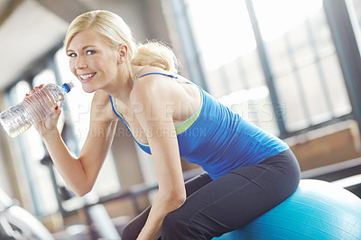Buy stock photo Tired, ball or portrait of woman drinking water on break in exercise, workout or fitness training in gym. Fatigue, healthy girl or thirsty sports athlete with bottle for wellness, rest or hydration 