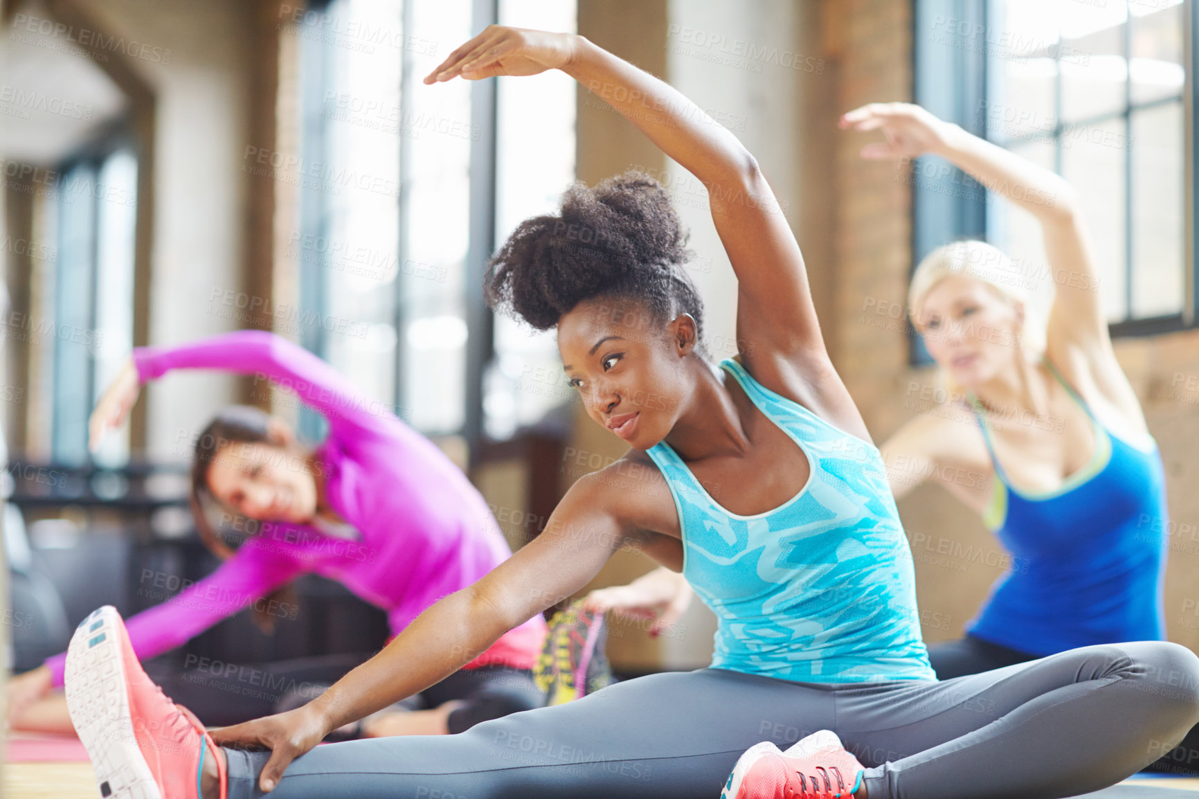 Buy stock photo Black woman, instructor and yoga class at gym, stretch and yogi trainer for exercise on mat. Female person, floor and confident for pilates or spiritual fitness, flexibility and health in performance