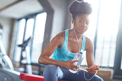 Buy stock photo Phone, earphones and portrait of black woman in gym with water, fitness app or online subscription. Health, wellness and girl checking music playlist on smartphone with bottle, break and sports club