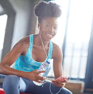 Buy stock photo Fitness app, headphones and portrait of black woman in gym with water, phone or online subscription. Health, wellness and girl checking music playlist on smartphone with bottle, break and sports club