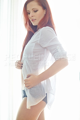 Buy stock photo Woman, calm and sexy or seductive with shirt for temptation, flirty and sensual in bedroom with confidence. Girl, teasing and serious in home for desire or sensuality, alluring and hot with underwear