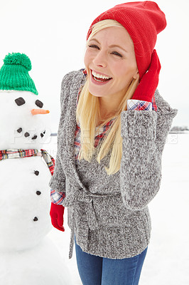 Buy stock photo Christmas, woman and snowman outdoor in winter, happy smile and cold  in Austria during festive holiday or season. Young female, happiness and fun outside in nature, smiling and laugh with portrait