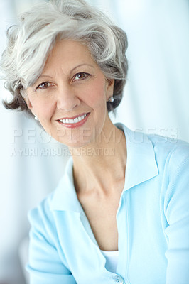 Buy stock photo Portrait of one happy senior caucasian woman with grey hair enjoying free time at home. Face of carefree, wise and cheerful retired lady smiling, feeling optimistic about life and ageing gracefully