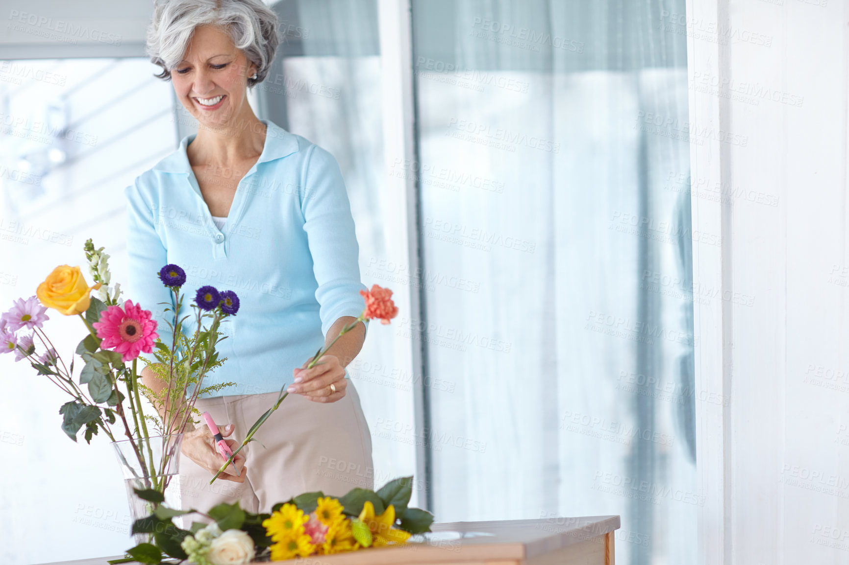 Buy stock photo Senior woman, happy and flowers on patio for beauty, natural or romantic gesture at house. Retired female, bouquet and arranging plants outside for decoration, ornament or colorful in retirement home