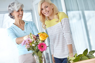 Buy stock photo Portrait, mom or happy woman with flowers in home together with joy, love and wellness for gardening. Mothers day, mature or daughter bonding in house with family, parent and gift present in Germany