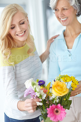 Buy stock photo Present, parent and happy woman with flowers in home together with love, pride or wellness for gardening. Mothers day, senior lady or daughter bonding in family house with mom, plants or gift in USA